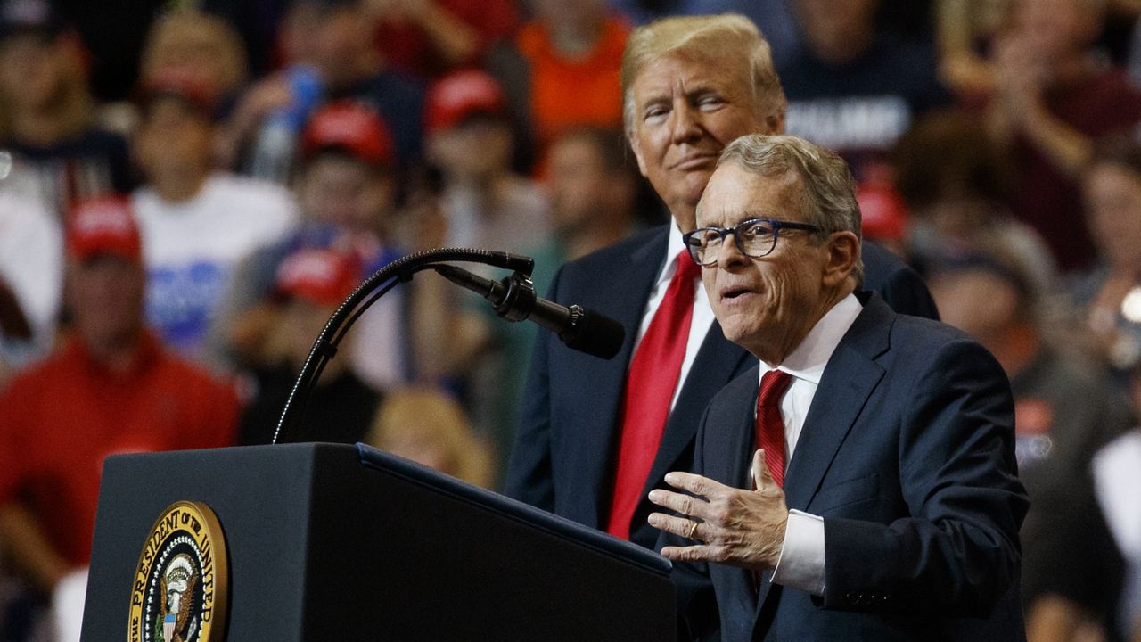 President Donald Trump stands with gubernatorial candidate Mike DeWine as he speaks during a rally, at the IX Center, in Cleveland, Monday, Nov. 5, 2018. (AP Photo/Carolyn Kaster)