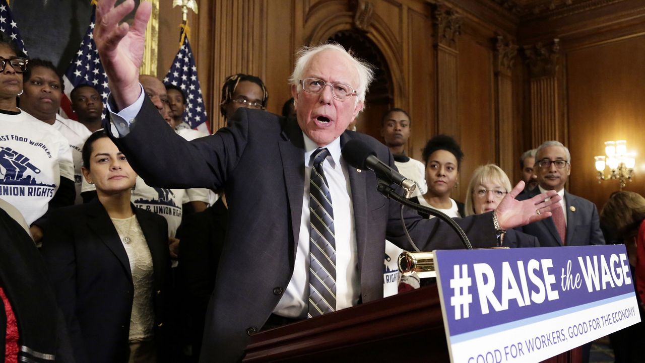 FILE PHOTO: Now-Senate Budget Committee Chair, then-Ranking Member Sen. Bernie Sanders (I-VT) gives his support to a bill to raise the minimum wage to $15 by 2024, surrounded by low-wage fast food workers, on Capitol Hill in Washington, Wednesday, Jan. 16, 2019. (AP Photo/J. Scott Applewhite)