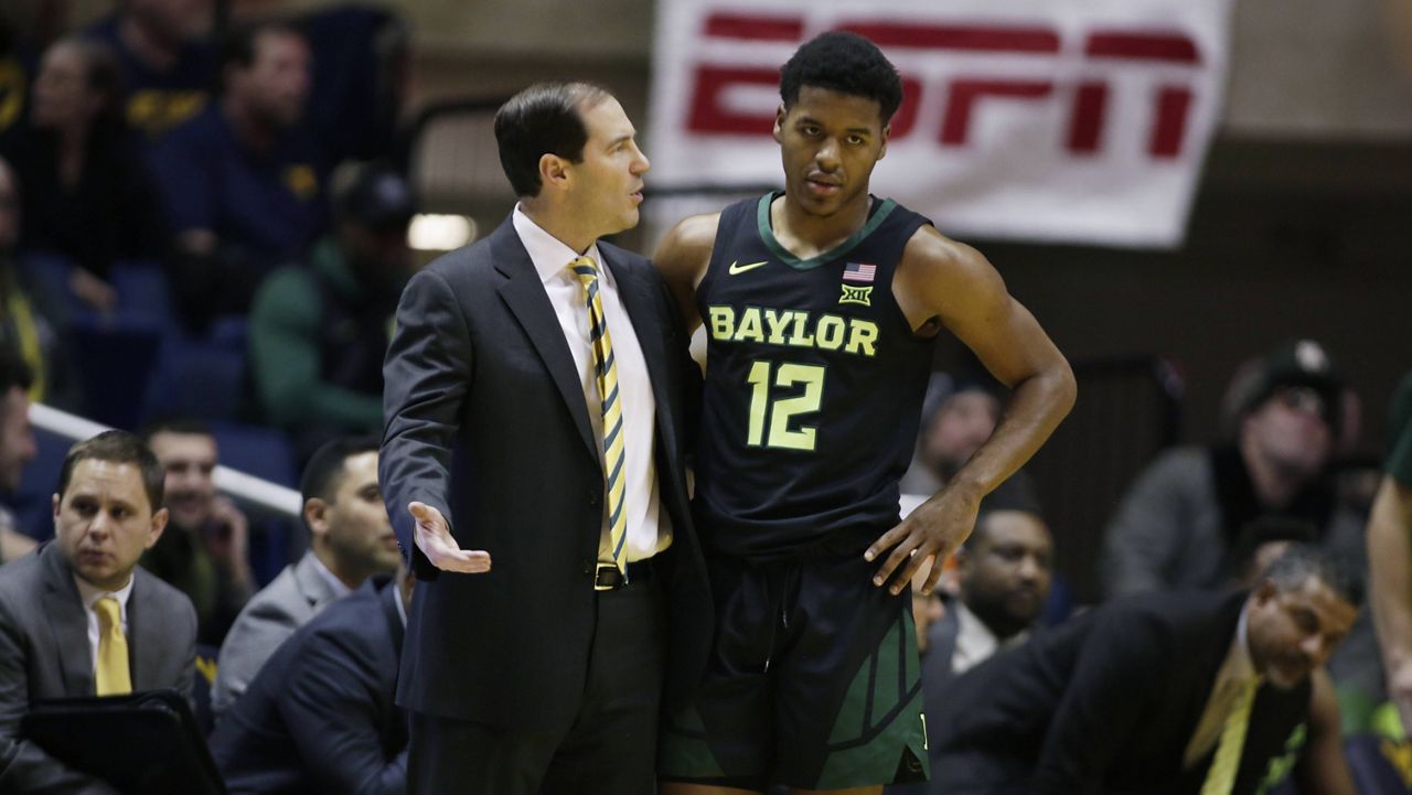 Baylor coach Scott Drew talks with star guard Jared Butler during a game in January 2019. (AP Photo/Raymond Thompson/File)