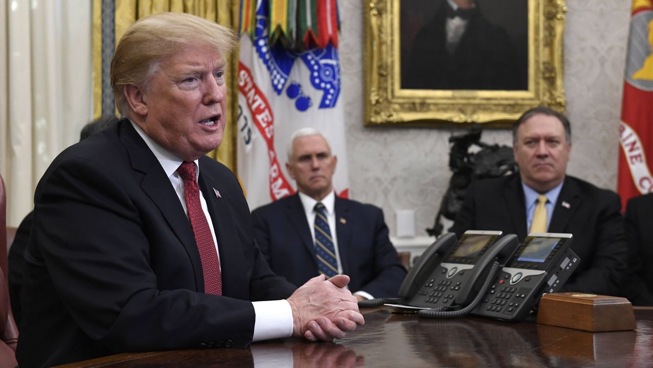 President Donald Trump is pictured in the Oval Office with Vice President Mike Pence and Secretary of State Mike Pompeo on Jan. 31, 2019.