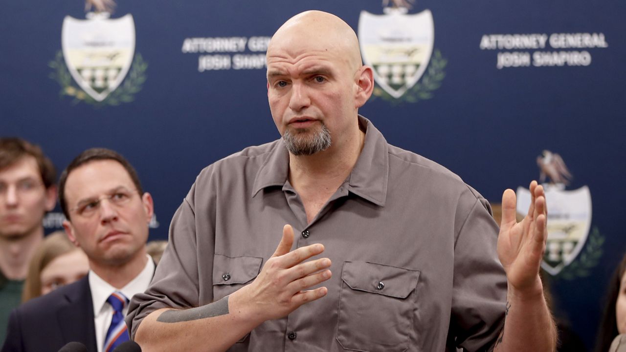 Pennsylvania Lieutenant Governor John Fetterman, right, speaks as he stands beside state Attorney General Josh Shapiro during a news conference about legal action in the dispute between health insurance providers UPMC and Highmark, Thursday, Feb. 7, 2019, in Pittsburgh. (AP Photo/Keith Srakocic)