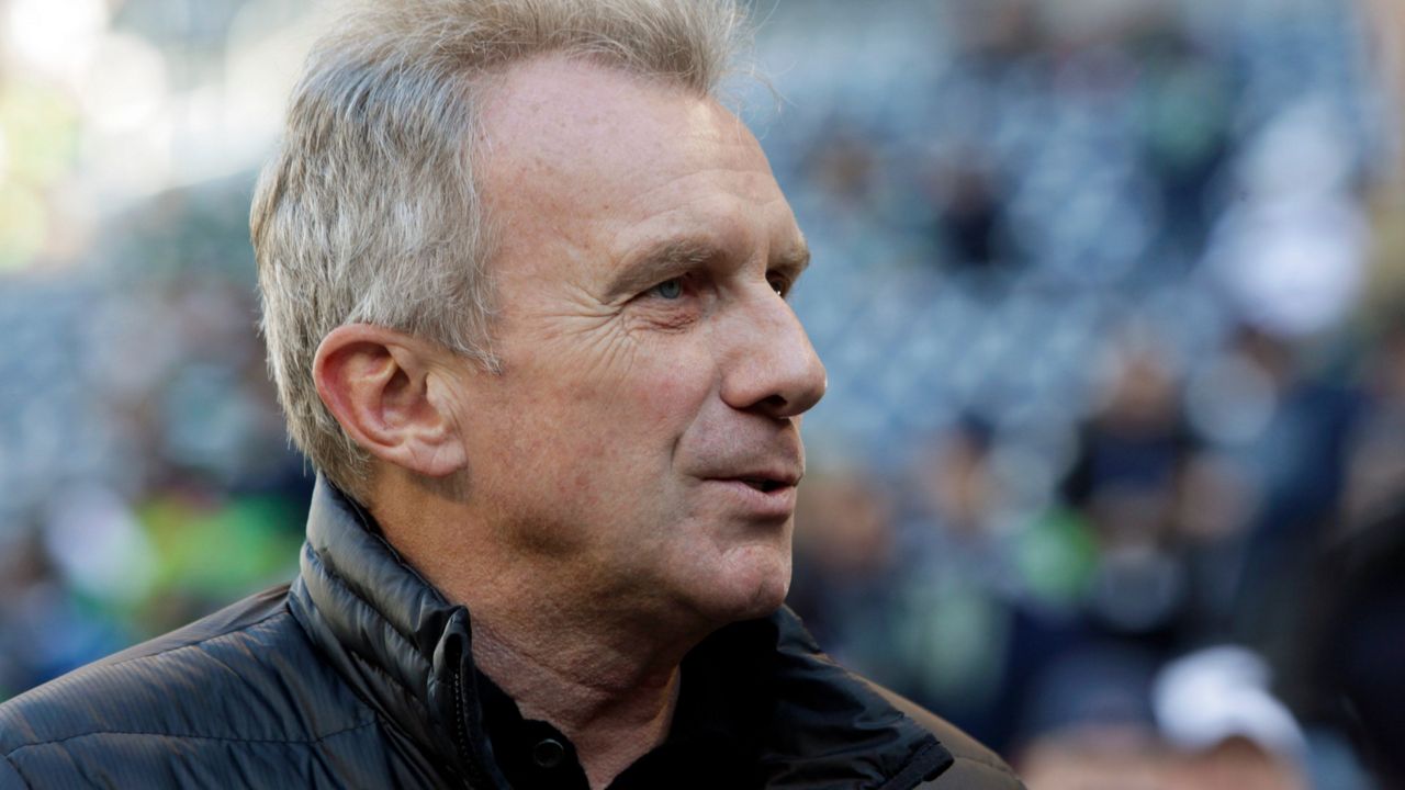 Former San Francisco 49ers quarterback Joe Montana stands on the sidelines, Sunday, Dec. 14, 2014, in Seattle. (AP Photo/John Froschauer)