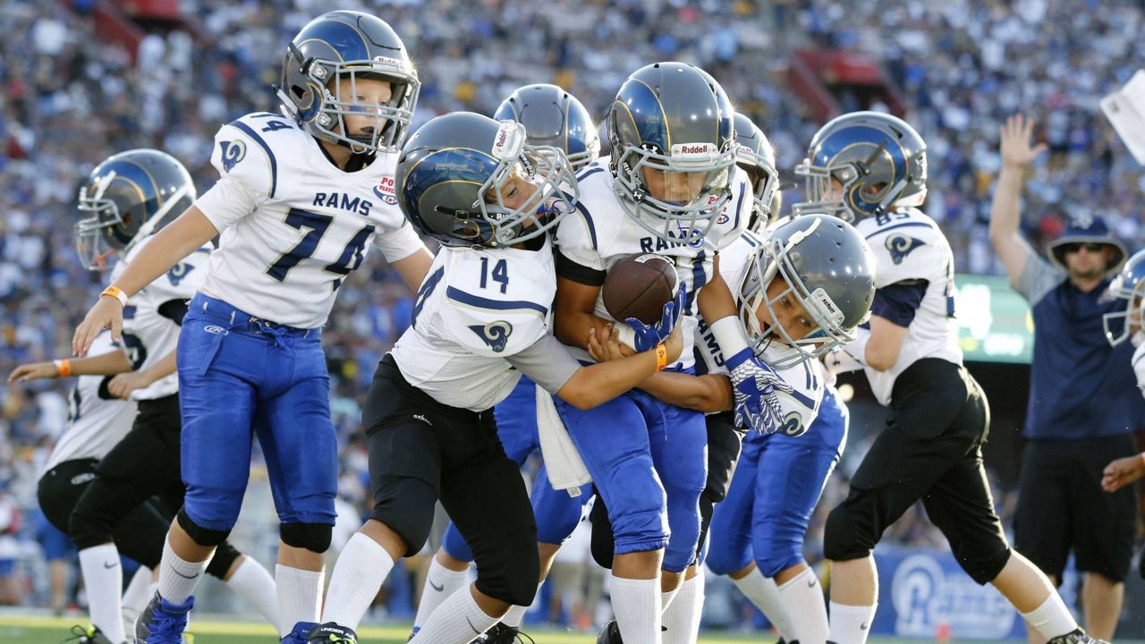 Youngsters play in a pee-wee football game during halftime of a preseason NFL game between the Los Angeles Rams and the Dallas Cowboys in LA on Aug 13, 2016. (AP Photo/Ryan Kang)