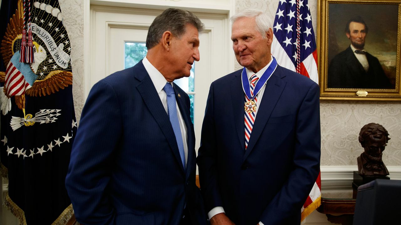 Sen. Joe Manchin, D-W.Va., left, talks with former NBA basketball player and general manager Jerry West, after President Donald Trump presented West with the Presidential Medal of Freedom, in the Oval Office of the White House, Thursday, Sept. 5, 2019, in Washington. (AP Photo/Alex Brandon)