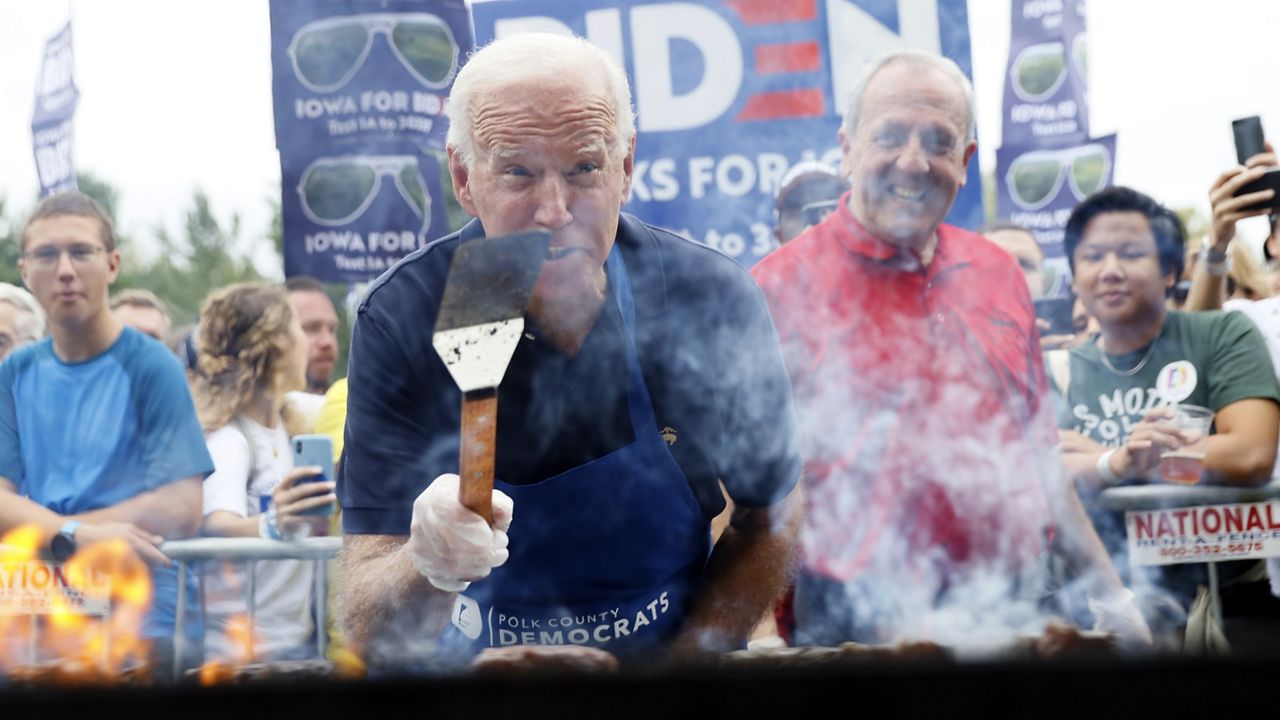 File Photo: Then-presidential candidate Joe Biden works the grill during the Polk County Democrats Steak Fry, Saturday, Sept. 21, 2019, in Des Moines, Iowa. (AP Photo/Charlie Neibergall)