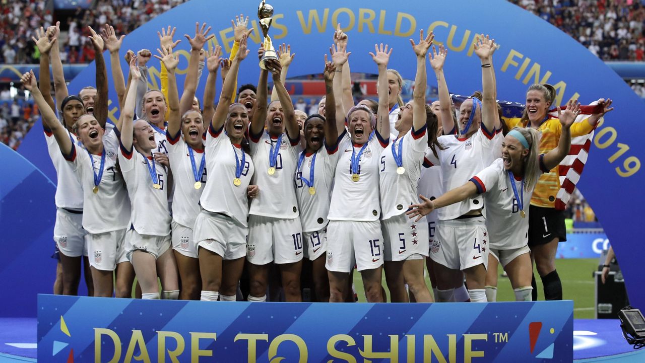 The U.S. women's national team celebrates with the trophy after winning the Women's World Cup final vs. The Netherlands at the Stade de Lyon in Decines, outside Lyon, France on July 7, 2019. (AP Photo/Alessandra Tarantino)