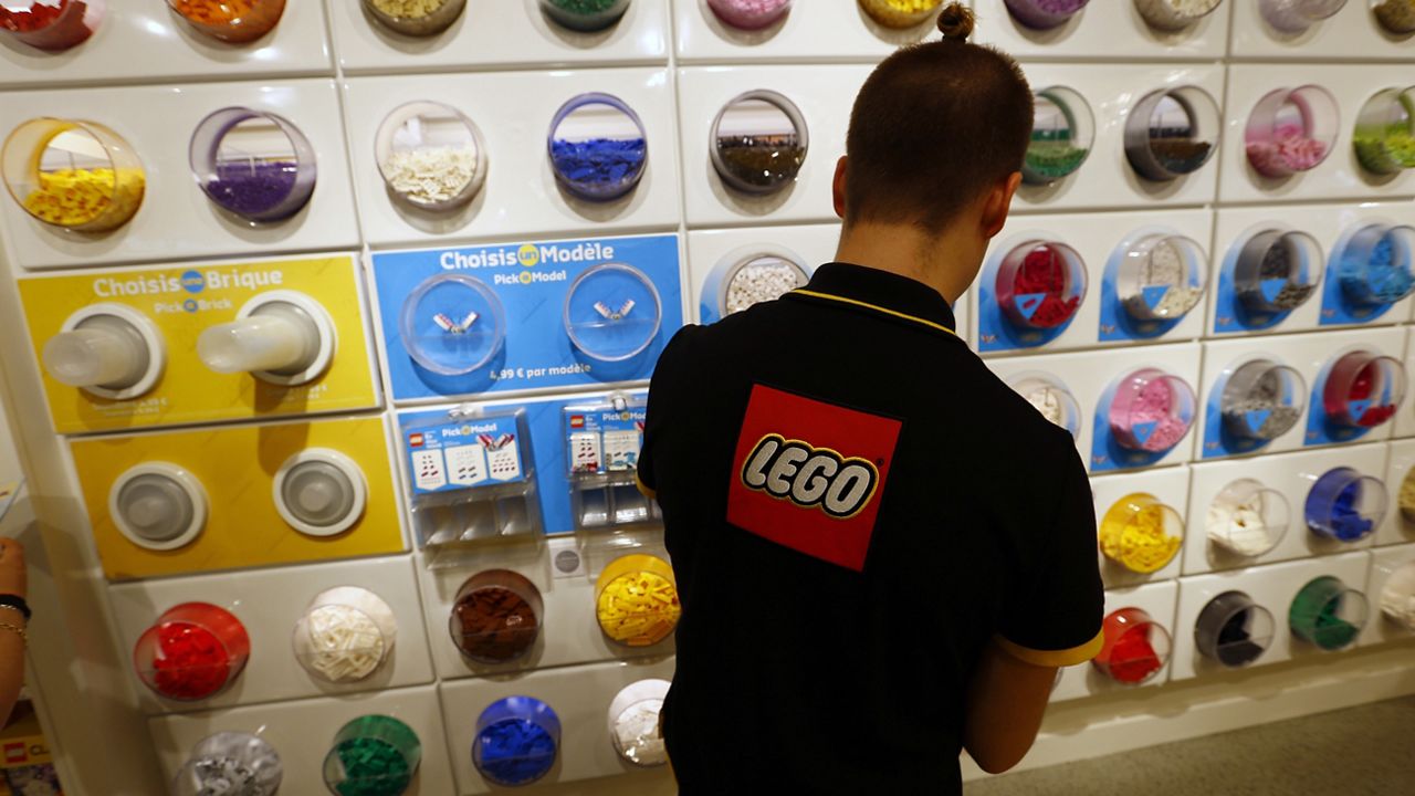 FILE- In this April 5, 2016 file photo, an employee sorts Legos in the the new LEGO flagship store unveiled as part of the new Les Halles shopping mall during the press visit in Paris. (AP Photo/Francois Mori, File)