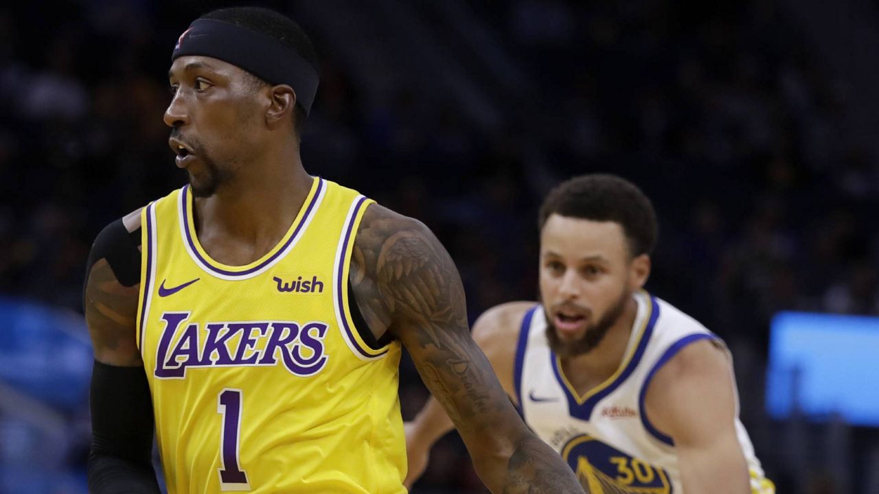 Lakers' Kentavious Caldwell-Pope, left, drives the ball past Golden State Warriors' Stephen Curry during a preseason NBA game, Oct. 18, 2019, in San Francisco. (AP/Ben Margot)