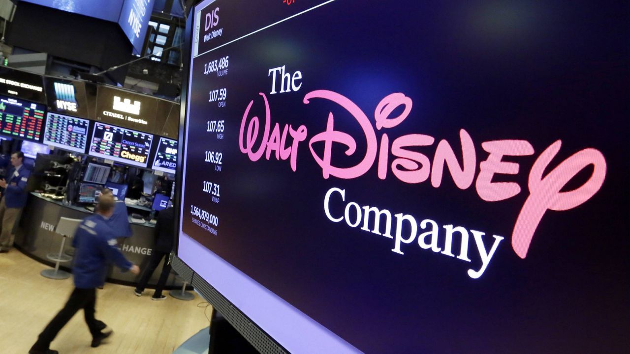 In this Aug. 8, 2017, file photo, The Walt Disney Co. logo appears on a screen above the floor of the New York Stock Exchange. (AP Photo/Richard Drew, File)