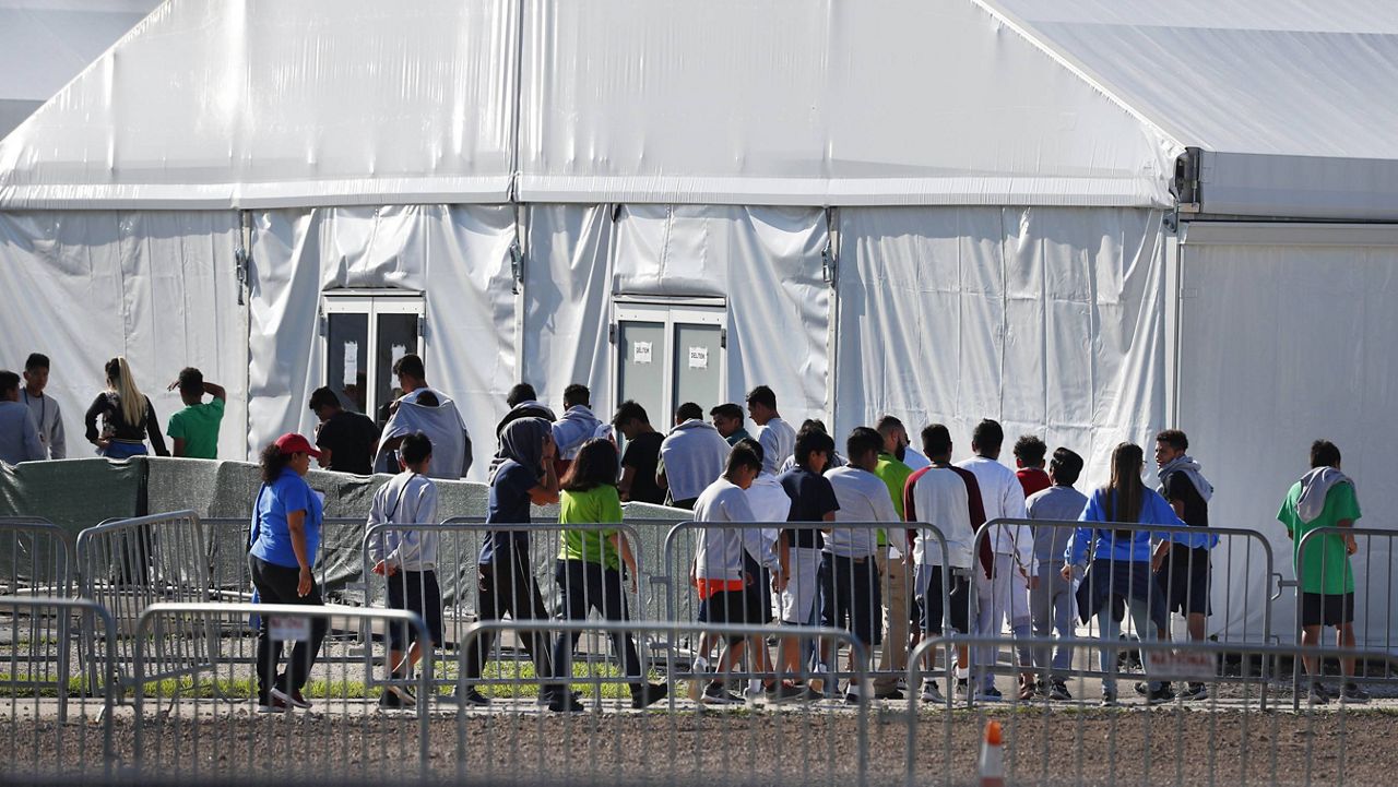 In this Feb. 19, 2019, file photo, children line up to enter a tent at the Homestead Temporary Shelter for Unaccompanied Children in Homestead, Fla. (AP Photo/Wilfredo Lee, File)