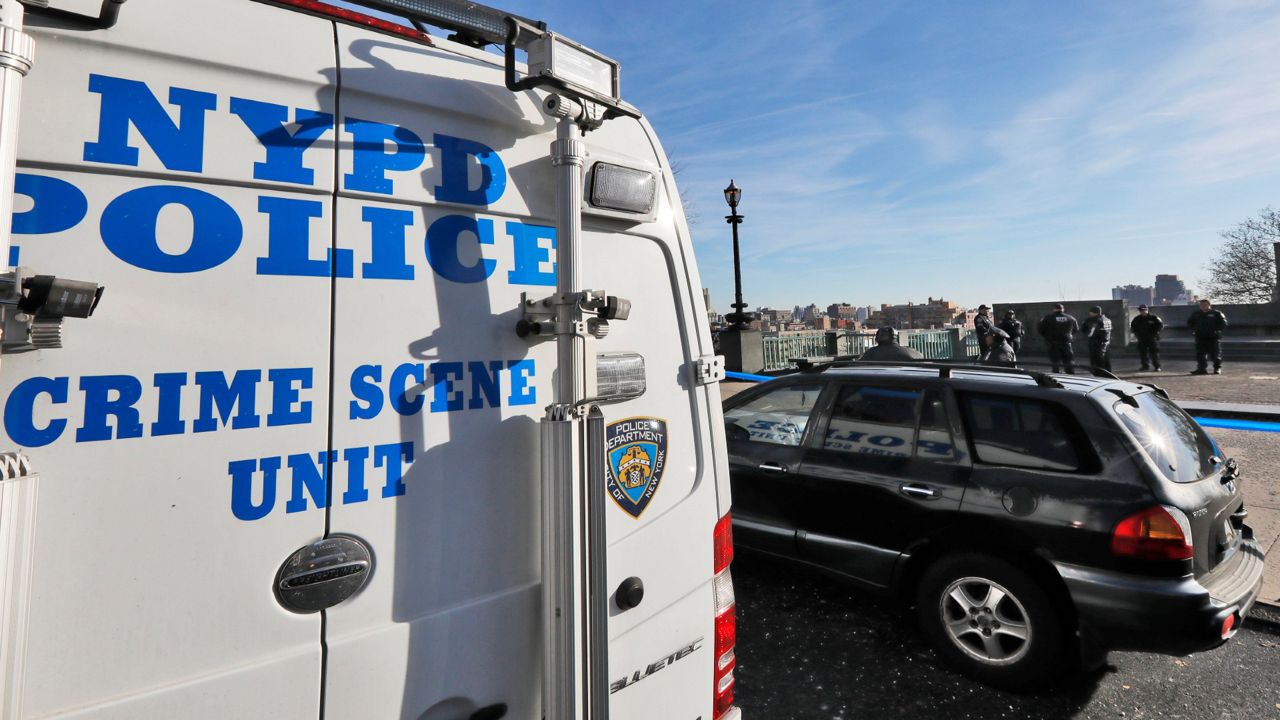 A New York City Police Dept. Crime Scene Unit and officers assemble at an entrance to Morningside Park along Manhattan's Upper West Side, Thursday, Dec. 12, 2019, in New York.