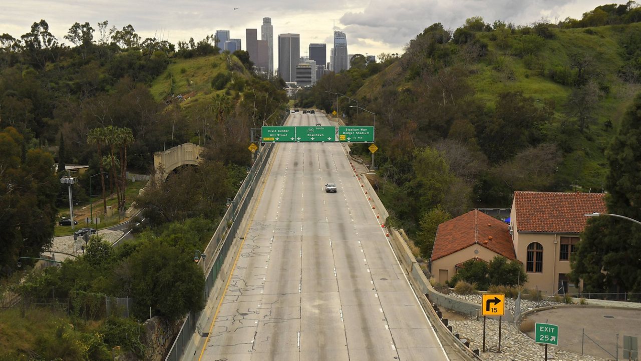 In this file photograph, extremely light traffic moves along the 110 Harbor Freeway toward downtown mid afternoon, Friday, March 20, 2020, in Los Angeles. (AP Photo/Mark J. Terrill)