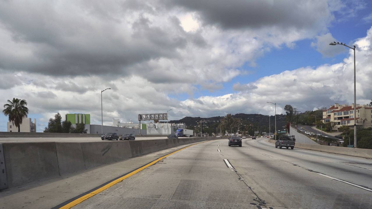 In this March 23, 2020 file photo, extremely light traffic moves along the 101 Hollywood Freeway as storm clouds blow through in the Hollywood area of L.A. (AP/Richard Vogel)