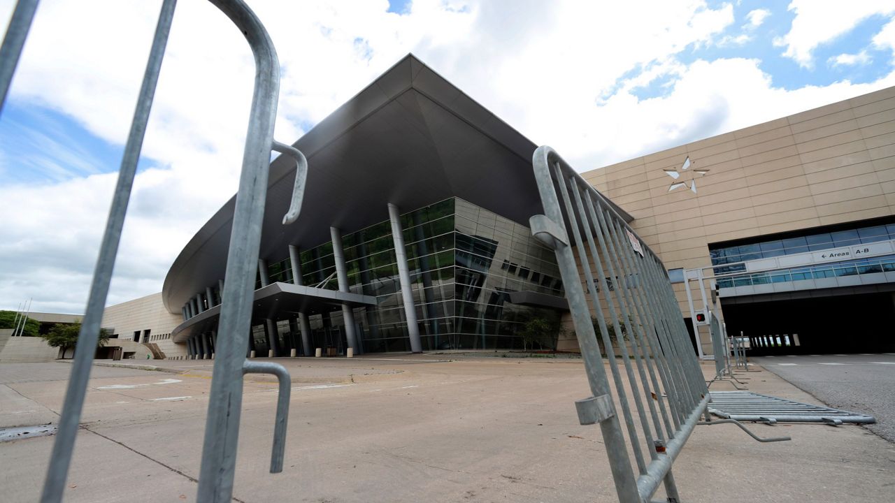 Barricades sign in front of an entrance to the Kay Bailey Hutchison Convention Center in downtown Dallas, Tuesday, March 31, 2020. (Associated Press)