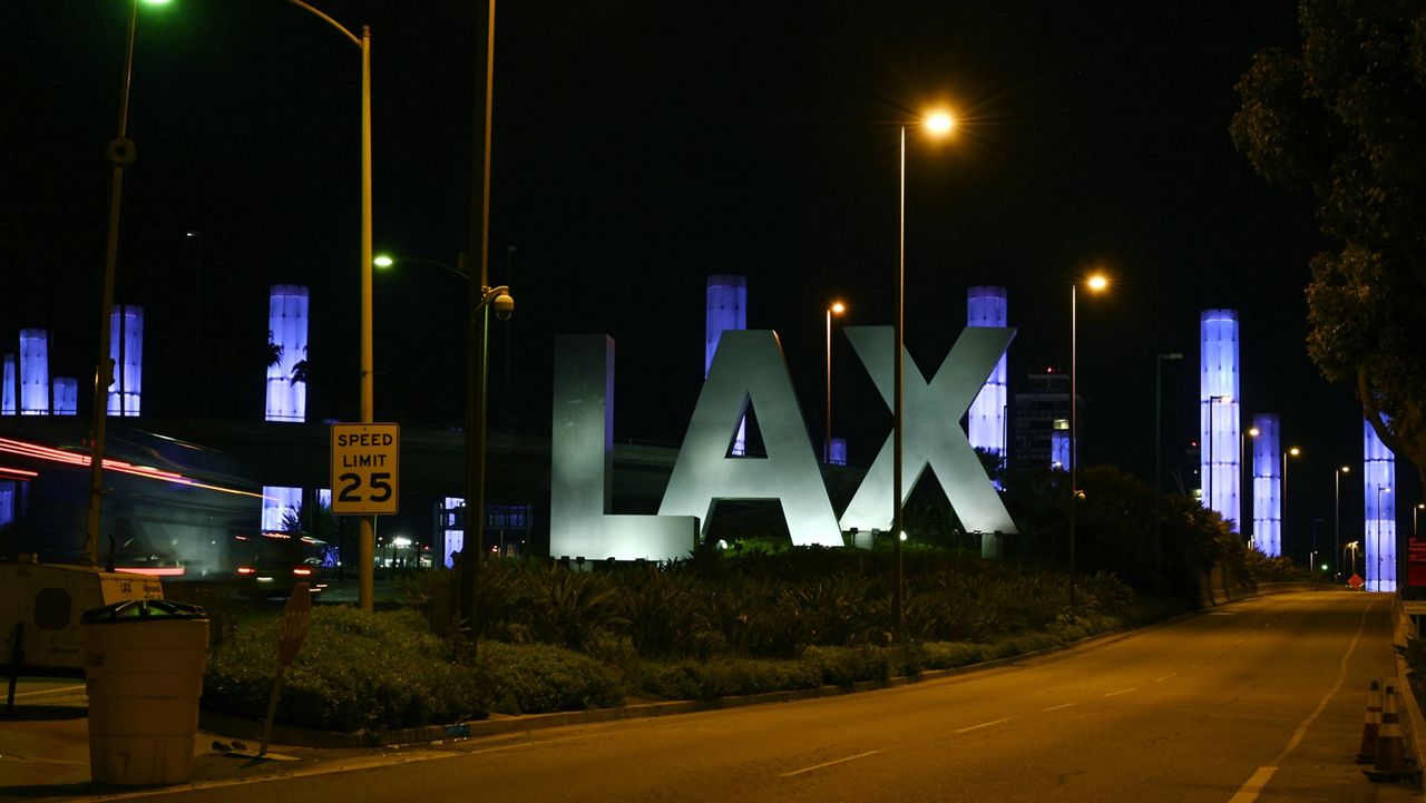 The LAX Gateway Kinetic Light Pylons are seen lit up in blue near Los Angeles International Airport, Friday, April 10, 2020, in Los Angeles. (AP Photo/Mark J. Terrill)