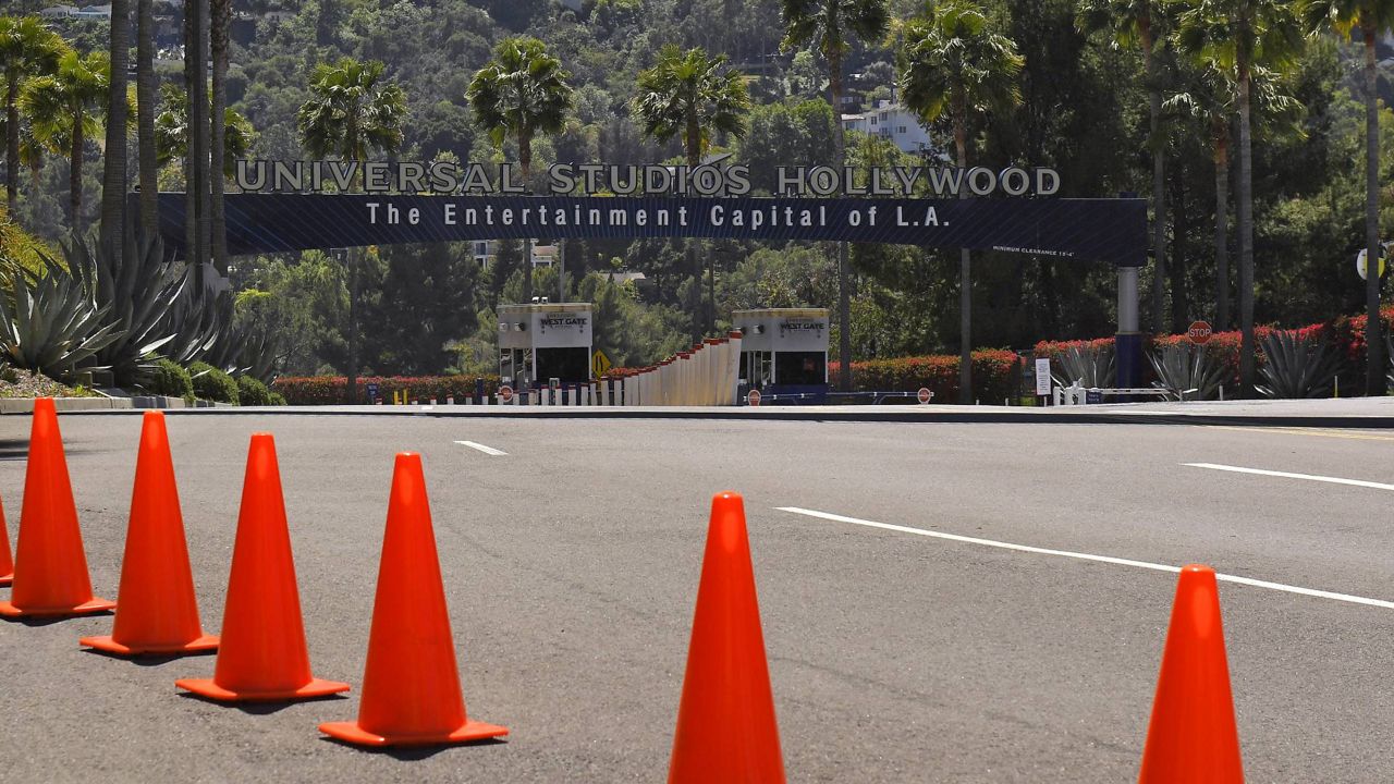 Cones block the entrance to a shuttered Universal Studios Hollywood due to the coronavirus outbreak, Wednesday, April 15, 2020, in Universal City, Calif. (AP Photo/Mark J. Terrill)