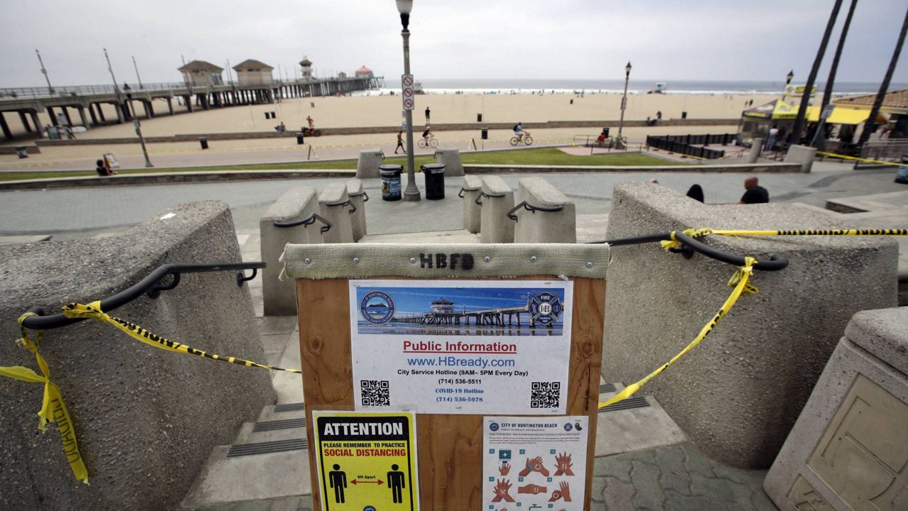 A sign gives social distance and hand washing guidelines Thursday, April 30, 2020, in Huntington Beach, Calif. Of the 18 deaths reported Wednesday, seven were skilled nursing facility residents. (AP Photo/Marcio Jose Sanchez)