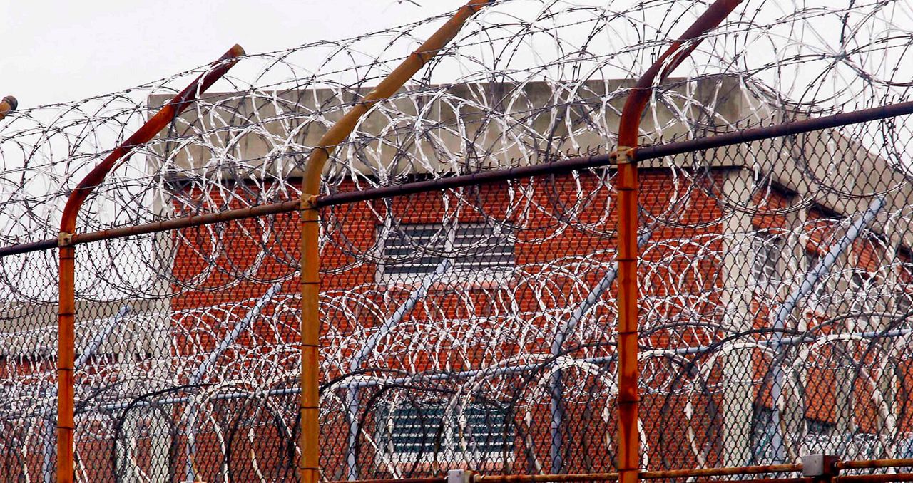 Image of barb wire fencing outside of a prison. (AP Image/File)