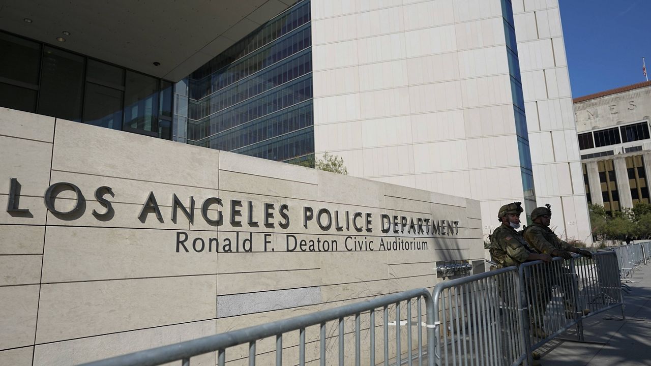 Members of the U.S. National Guard stand outside the Los Angeles Police Department, Wednesday, June 3, 2020, in Los Angeles in response to protests over the death of George Floyd. (AP Photo/Ashley Landis)