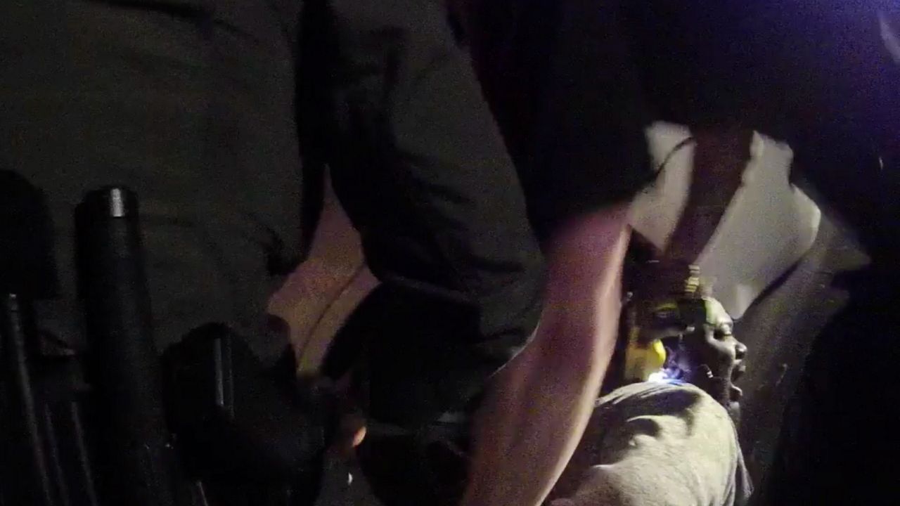 In this image made from a March 28, 2019, body-worn camera video provided by the Austin Police Department in Texas, Williamson County deputies hold down Javier Ambler as one of them uses a Taser on Ambler’s back during his arrest in Austin, Texas. (Austin Police Department via AP)