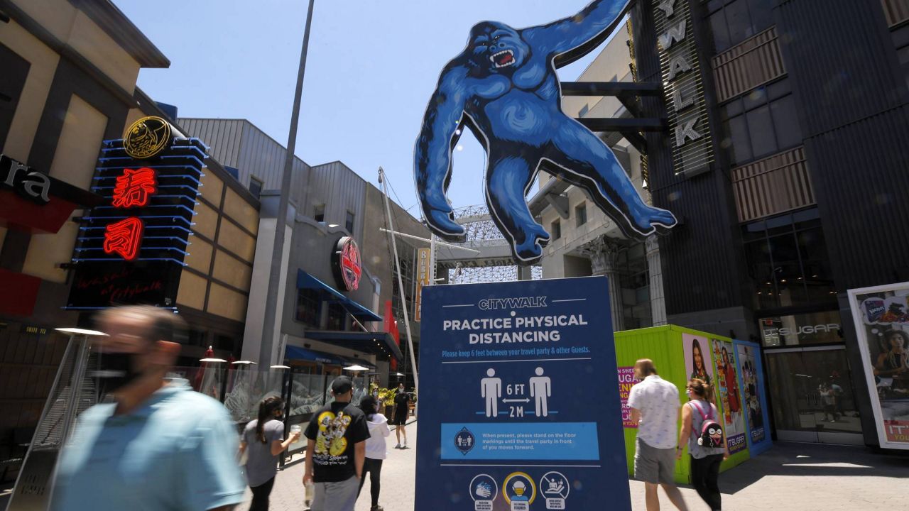 People walk through Universal CityWalk, June 11, 2020, near Universal City, Calif. (AP/Mark J. Terrill)