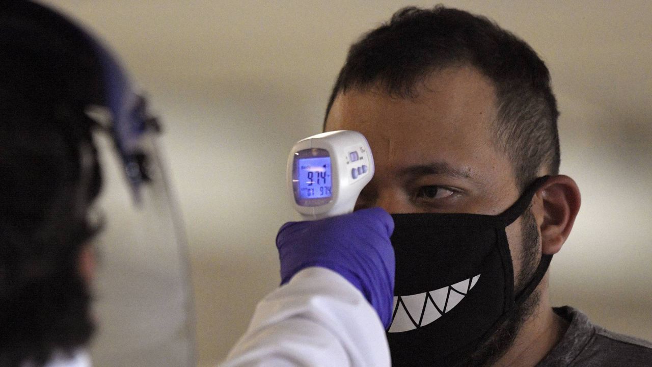 Jose Ramirez has his temperature checked before entering Universal CityWalk, Thursday, June 11, 2020, near Universal City, Calif. (AP/Mark J. Terrill)