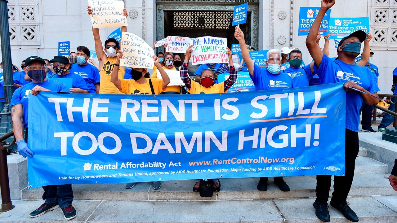 Housing justice advocates and mobilizers with the Rental Affordability Act share their rallying cry that 'The Rent is Too Damn High!" at a press conference urging the county and city of Los Angeles to undertake radical new thinking and approaches on housing the homeless. (Jordan Strauss/AP Images for AIDS Healthcare Foundation)
