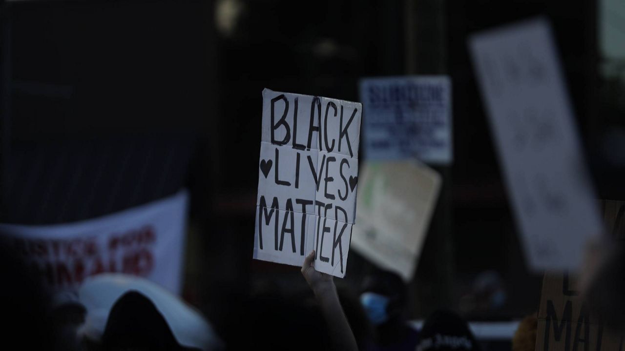 FILE - A "Black Lives Matter" sign is seen during protests on Saturday, June 13, 2020, near the Atlanta Wendy's where Rayshard Brooks was shot and killed by police. (AP/Brynn Anderson)