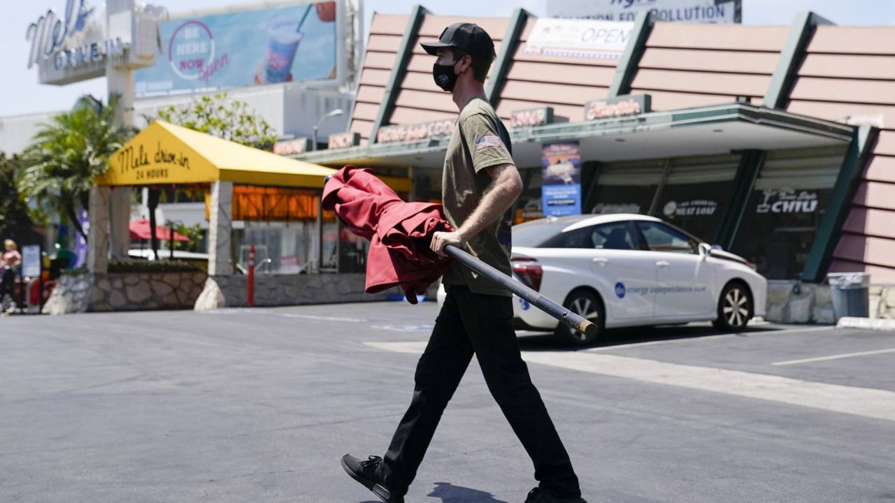 Chasen Weiss, whose family owns Mel's Drive-In, wears a mask while working, July 2, 2020, in West Hollywood, Calif. (AP/Ashley Landis)