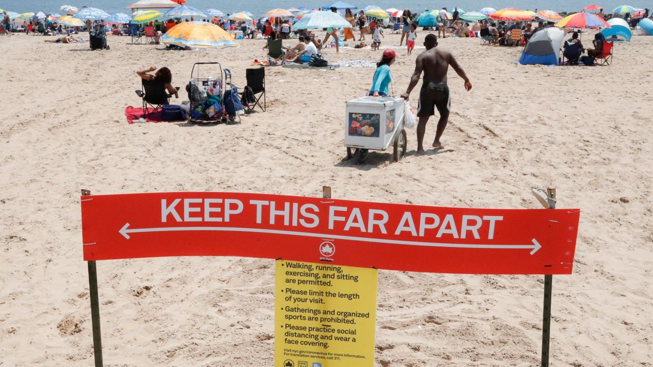 Revelers enjoy the beach at Coney Island, Saturday, July 4, 2020, in the Brooklyn borough of New York.