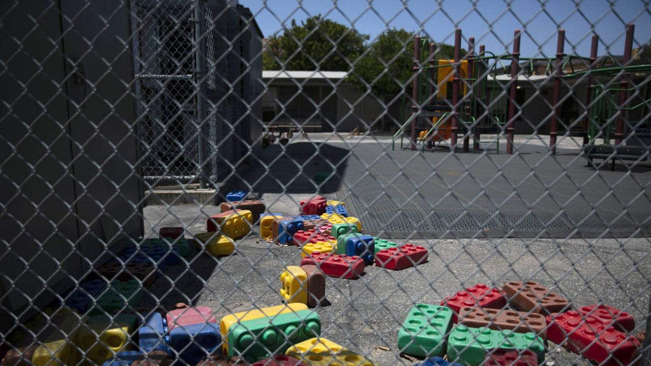Dusty Lego-style toys are scattered in the playground of an elementary school in Los Angeles, July 17, 2020. (AP Photo/Jae C. Hong)