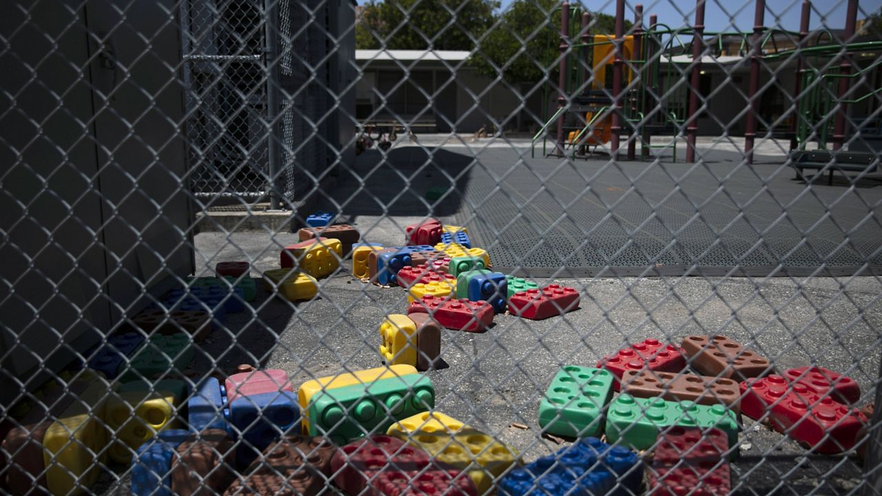 Dusty Lego-style toys are scattered in the playground of an elementary school in Los Angeles, Friday, July 17, 2020. (AP Photo/Jae C. Hong)