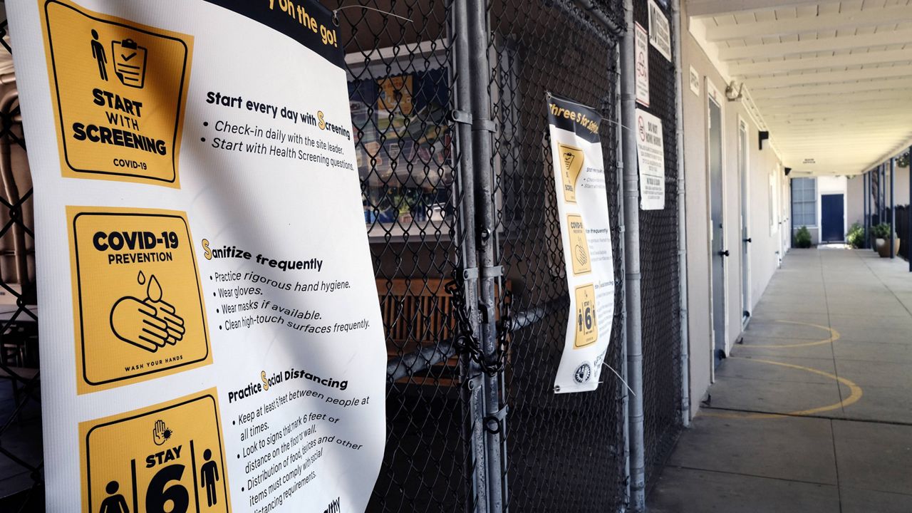 (AP Photo/Richard Vogel, File) In this July 13, 2020, file photo, a chain-link fence lock is seen on a gate at a closed Ranchito Elementary School in the San Fernando Valley section of Los Angeles.