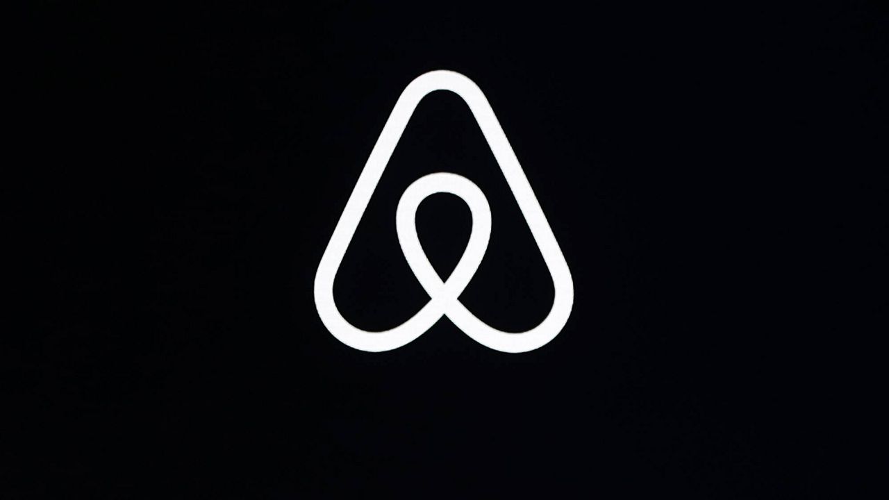 This Feb. 22, 2018, file photo, shows an Airbnb logo during an event in San Francisco. (AP Photo/Eric Risberg, File)
