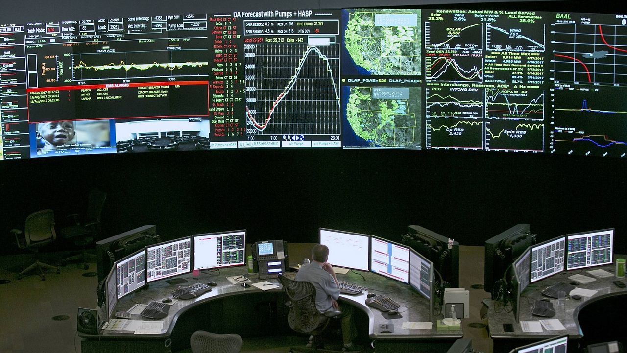 In this Aug. 18, 2017, file photo, electrical power flow and conditions are monitored at the California Independent System Operator (California ISO) grid control center in Folsom, Calif. Executives with the California Independent System Operator said statewide rolling blackouts could affect up to 3.3 million California homes. (Rich Pedroncelli/AP)