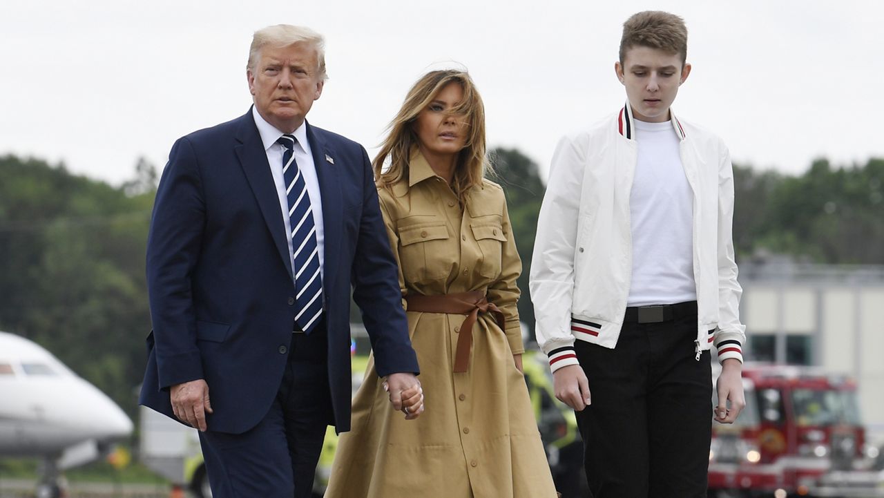 President Donald Trump, Melania Trump and their son, Barron Trump walk to board Air Force One at Morristown Municipal Airport in Morristown, N.J., Sunday, Aug. 16, 2020. (AP Photo/Susan Walsh)