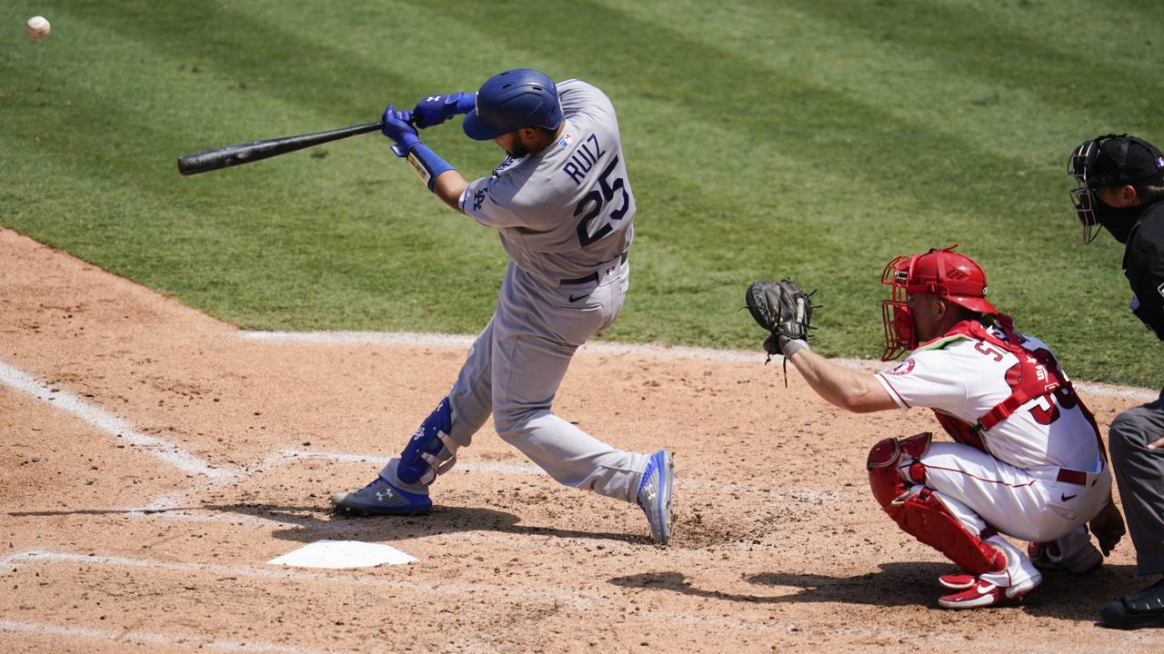 Los Angeles Dodgers Keibert Ruiz hits a solo home run during the third inning of a baseball game against the Los Angeles Angels Sunday, Aug. 16, 2020, in Anaheim, Calif. (AP Photo/Marcio Jose Sanchez)