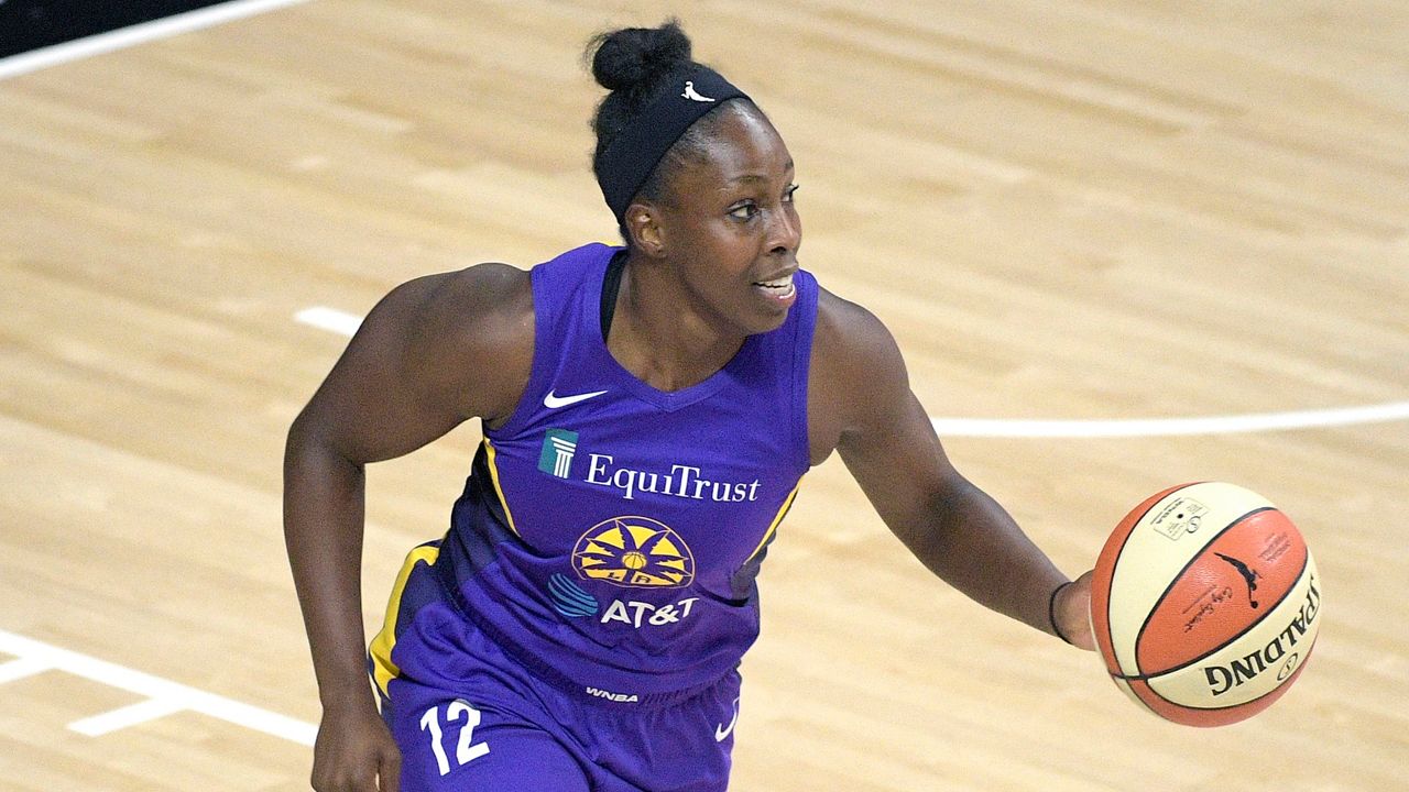 L.A. Sparks guard Chelsea Gray (12) brings the ball up the court during the first half of a WNBA basketball game against the Indiana Fever, Saturday, Aug. 15, 2020, in Bradenton, Fla. (AP Photo/Phelan M. Ebenhack)