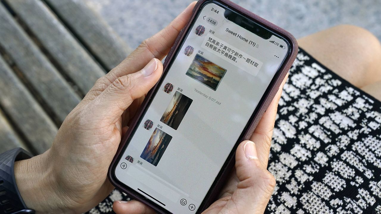 Sha Zhu, of Washington, shows the app WeChat on her phone, which she uses to keep in touch with family and friends in the U.S. and China. (AP Photo/Jacquelyn Martin) 