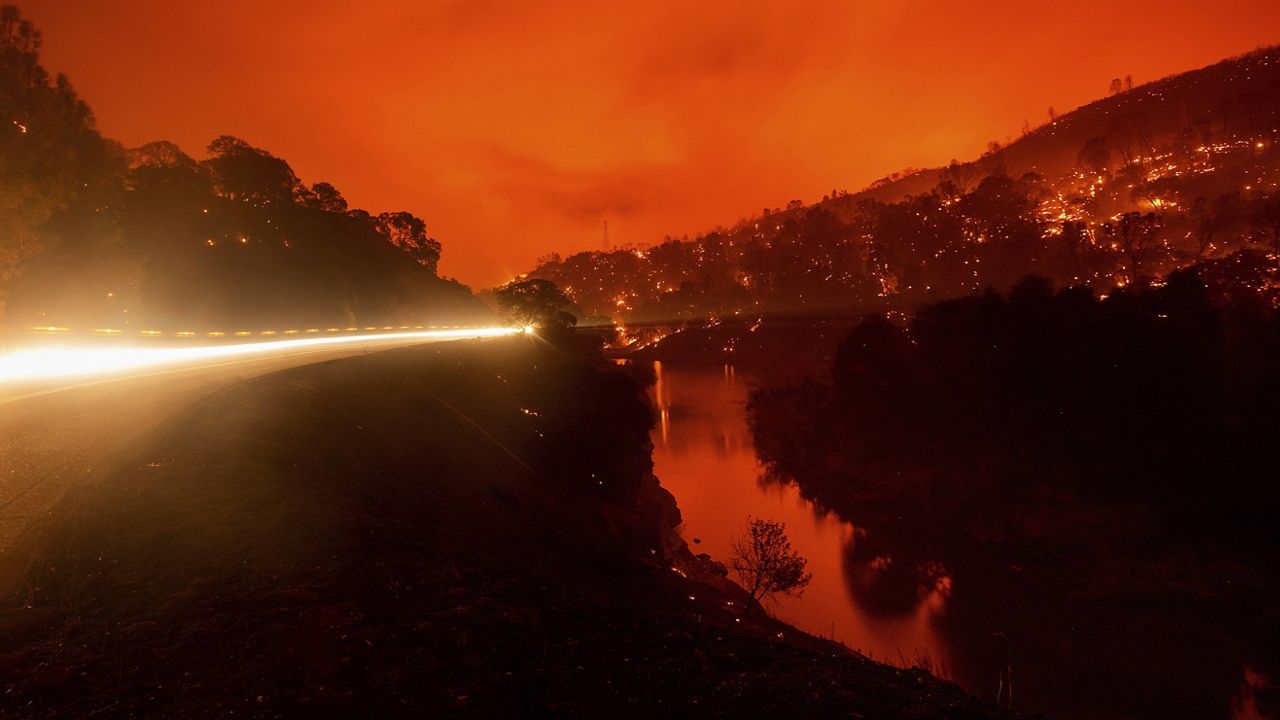 Embers burn along a hillside above Lake Berryessa as the LNU Lightning Complex fires tear through unincorporated Napa County, Calif., on Tuesday, Aug. 18, 2020. (AP Photo/Noah Berger)