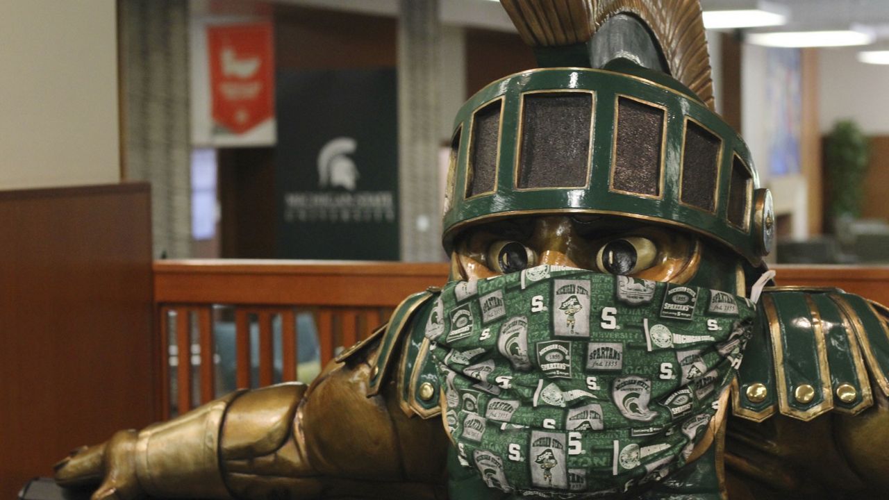 FILE - A face mask on the Sparty statue inside the the Michigan State University Student Union. (AP Photo/Anna Nichols)