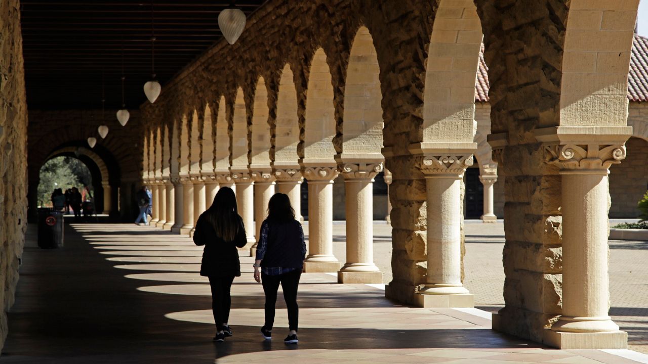 In this March 14, 2019, file photo students walk on the Stanford University campus in Santa Clara, Calif. (AP Photo/Ben Margot, File)
