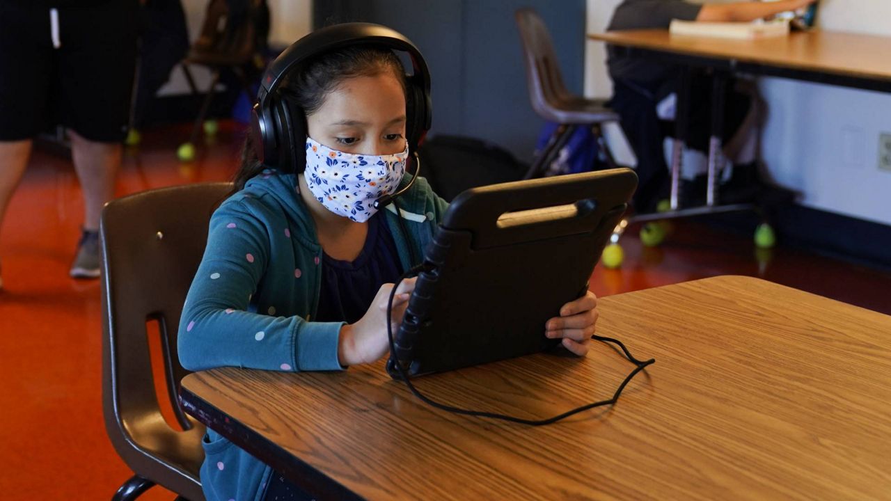 Los Angeles Unified School District students attend online classes at Boys & Girls Club of Hollywood in Los Angeles, Aug. 26, 2020. (AP Photo/Jae C. Hong)