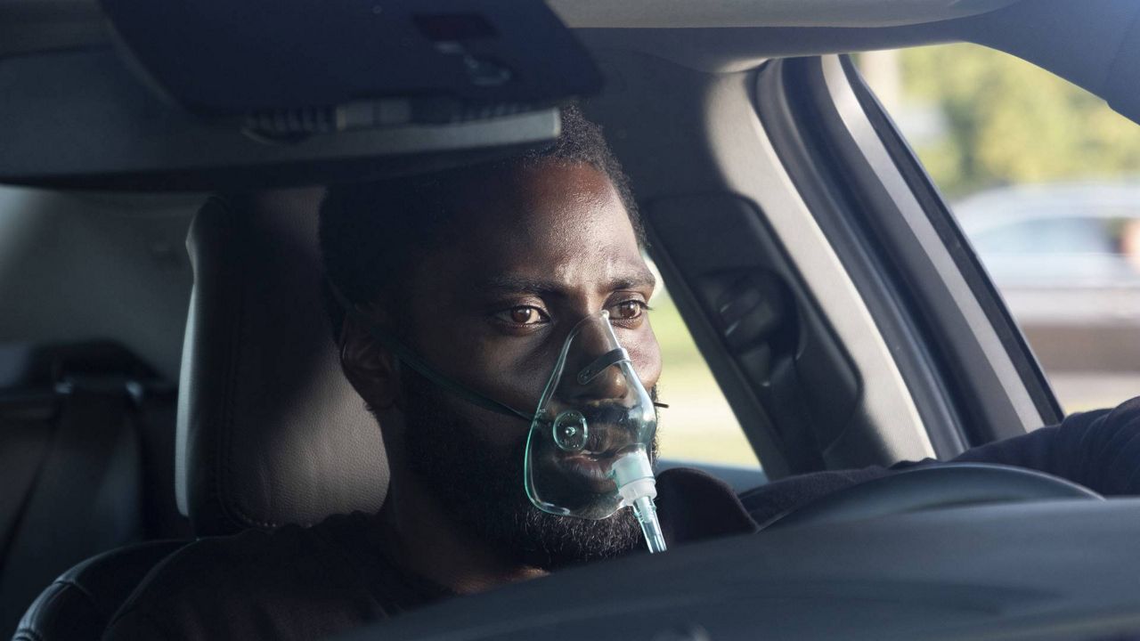 This image released by Warner Bros. Entertainment shows John David Washington in a scene from "Tenet." (Melinda Sue Gordon/Warner Bros. Entertainment via AP)
