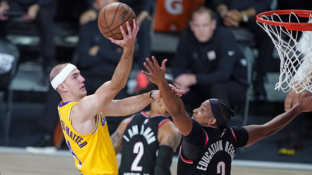 Los Angeles Lakers' Alex Caruso (4) drives against Portland Trail Blazers' CJ McCollum (3) during the second half of an NBA basketball first round playoff game Saturday, Aug. 29, 2020, in Lake Buena Vista, Fla. (AP Photo/Ashley Landis)