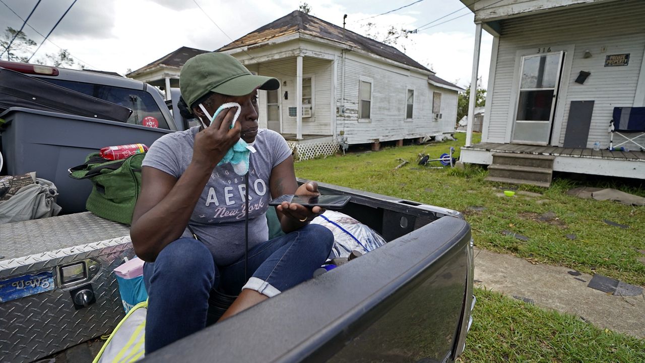 Linda Smoot, who evacuated from Hurricane Laura in a pickup truck with eight others, reacts as they return to see the damaged home of her niece for the first time, in Lake Charles, La., in the aftermath of the hurricane, Sunday, Aug. 30, 2020. (AP Photo/Gerald Herbert)