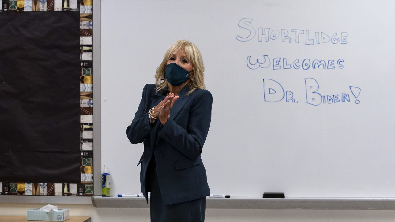 File Photo - Dr. Jill Biden walks past a dry erase board in a classroom that reads "Shortlidge Welcomes Dr. Biden," as she tours the Evan G. Shortlidge Academy in Wilmington, Del., Tuesday, Sept. 1, 2020. (AP Photo/Carolyn Kaster)