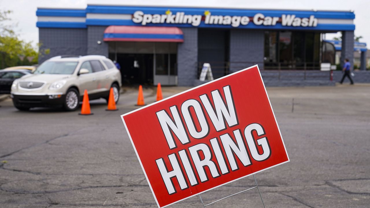 FILE - In this Sept. 2, 2020, file photo, a help wanted sign is displayed at car wash in Indianapolis. (AP Photo/Michael Conroy, File)