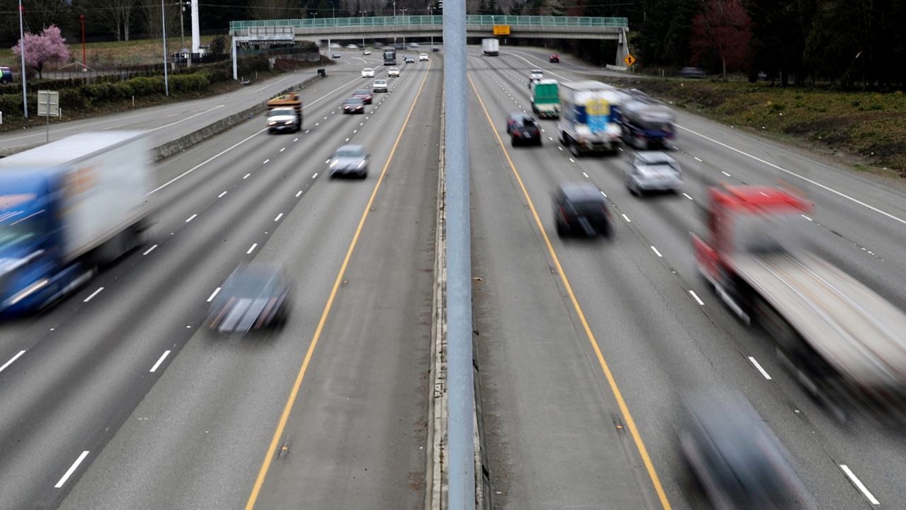 In this Monday, March 25, 2019, file photo, cars and trucks travel on Interstate 5 near Olympia, Wash.  (AP Photo/Ted S. Warren, File)