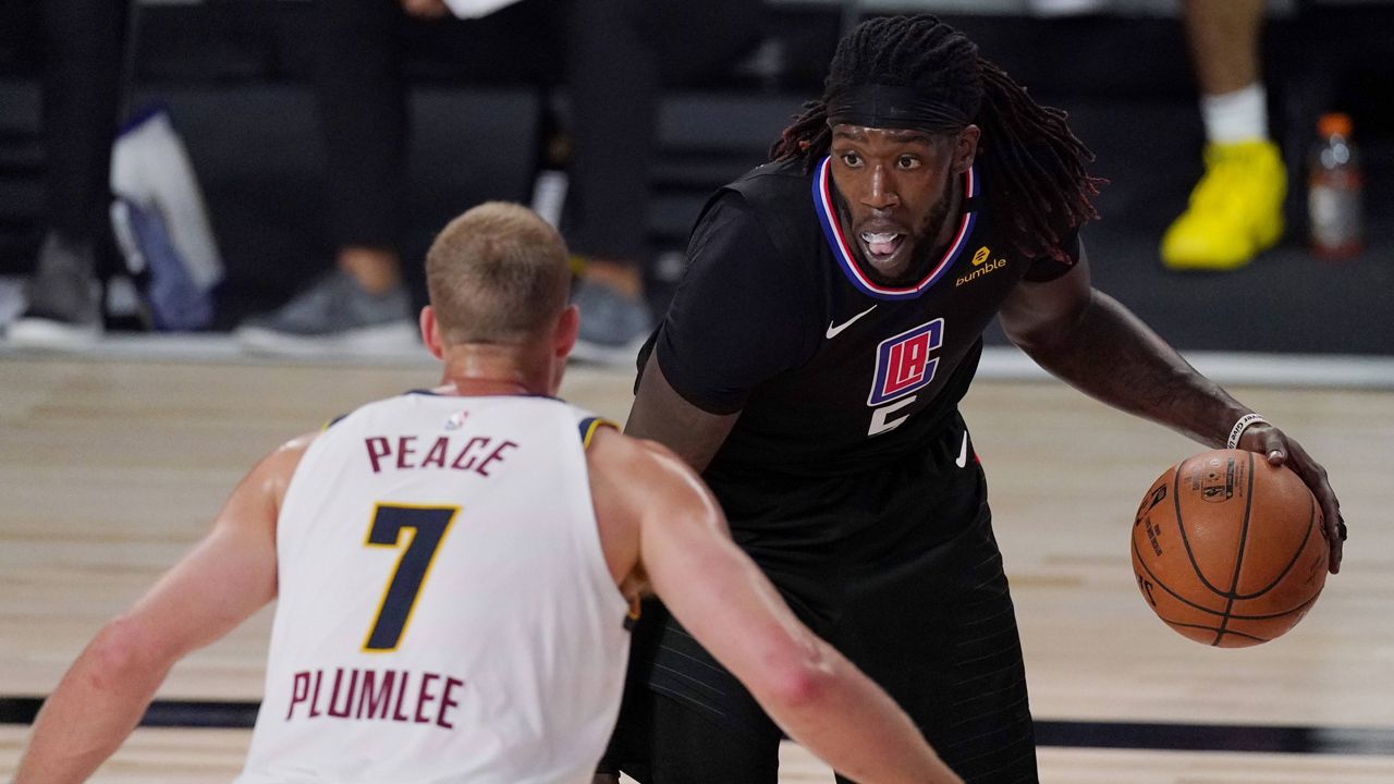 Los Angeles Clippers' Montrezl Harrell (5) is defended by Denver Nuggets' Mason Plumlee (7) in the second half of an NBA conference semifinal playoff basketball game Thursday, Sept 3, 2020, in Lake Buena Vista Fla. (AP Photo/Mark J. Terrill)
